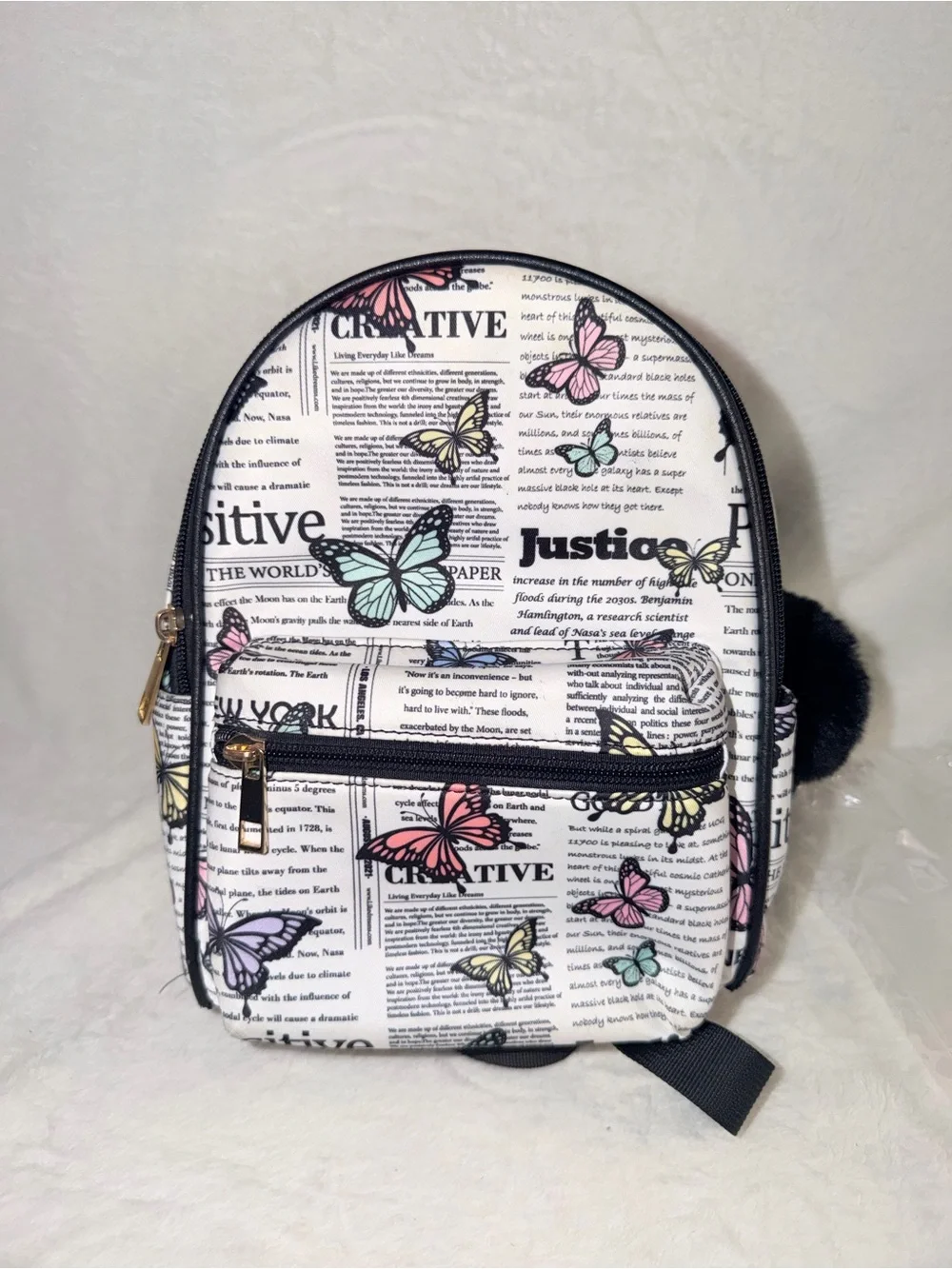 Like Dreams Butterfly Newspaper Mini Backpack Womens OS White Multicolor Pom Pom